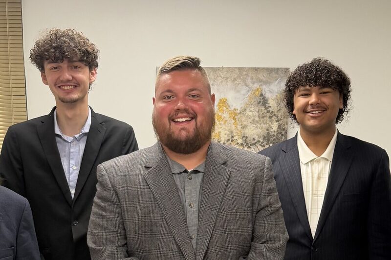 The Atlas Marketing Inc. team standing together in business attire